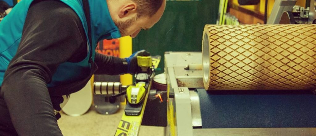 Technician sharpening ski edges